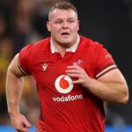 Wales rugby captain Dewi Lake looks dejected on the field after a late defeat against Scotland in the Six Nations, with teammates around him.