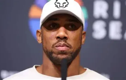 Anthony Joshua walking with his team outside Lagos court