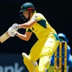 Georgia Voll celebrates scoring a century for Australia against India in ODI cricket