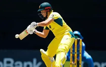 Georgia Voll celebrates scoring a century for Australia against India in ODI cricket