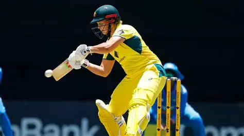 Georgia Voll celebrates scoring a century for Australia against India in ODI cricket