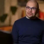 Google DeepMind CEO Sir Demis Hassabis speaking at the AI Impact Summit in Delhi, discussing AI risks and regulation.