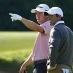 Jacob Bridgeman raising his club after a seven-under-par 64 to take a six-shot lead over Rory McIlroy at the Genesis Invitational.