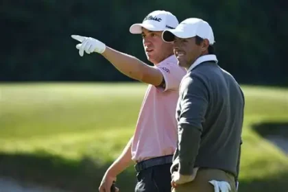 Jacob Bridgeman raising his club after a seven-under-par 64 to take a six-shot lead over Rory McIlroy at the Genesis Invitational.