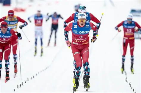 Johannes Klaebo crossing the finish line to win the 50km mass start classic at Milan-Cortina 2026, securing his sixth Olympic gold medal