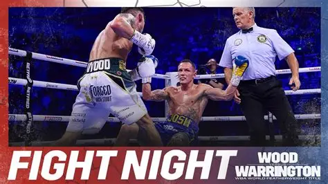 Leigh Wood celebrates his unanimous decision victory over Josh Warrington in Nottingham's Motorpoint Arena while Warrington looks on, exhausted.