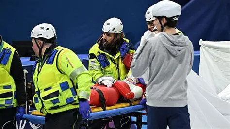 Polish short track skater Kamila Sellier lying on a stretcher after a crash at Milan-Cortina 2026.