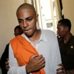 Tommy Schaefer escorted by Indonesian officials at airport