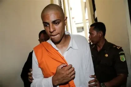 Tommy Schaefer escorted by Indonesian officials at airport