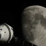 The four Artemis II astronauts in orange spacesuits walking at NASA’s Vehicle Assembly Building.