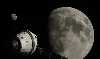 The four Artemis II astronauts in orange spacesuits walking at NASA’s Vehicle Assembly Building.