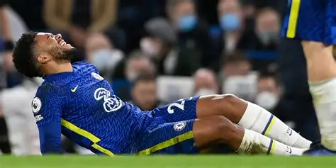 Chelsea captain Reece James reacts after suffering a hamstring injury during a match.