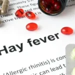 Person suffering from hay fever symptoms like sneezing and watery eyes outdoors