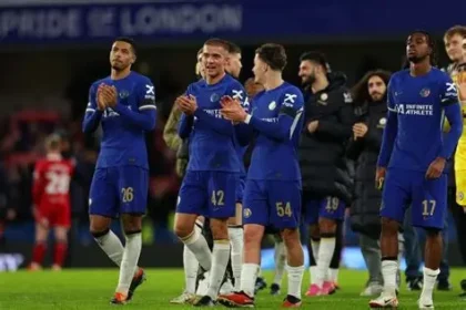 Chelsea players celebrating during a Premier League match amid club fine investigation.