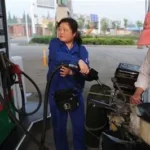 Cars lined up at fuel station in China during fuel price increase