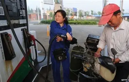 Cars lined up at fuel station in China during fuel price increase