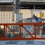 Palestinian villagers stand near the site where a man was killed during a settler attack in the West Bank.