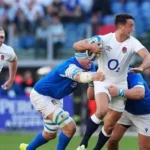 England winger Tommy Freeman tackled by Scotland players during Six Nations match