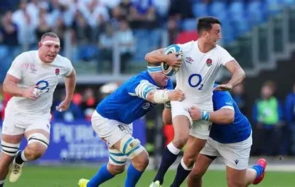 England winger Tommy Freeman tackled by Scotland players during Six Nations match