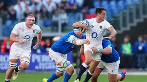 England winger Tommy Freeman tackled by Scotland players during Six Nations match
