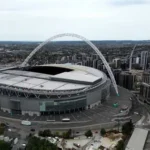 Fans entering Wembley Stadium during a football match with enhanced security checks
