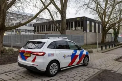 Police and firefighters outside a Jewish school building in Amsterdam after an explosion damaged the outer wall.