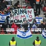 Anti-discrimination banner displayed in a football stadium during an international match
