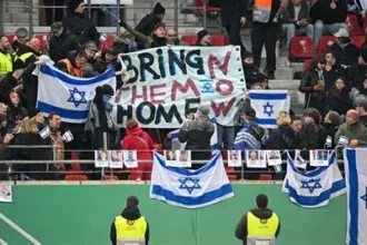 Anti-discrimination banner displayed in a football stadium during an international match
