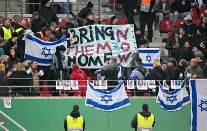 Anti-discrimination banner displayed in a football stadium during an international match