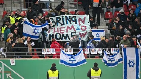 Anti-discrimination banner displayed in a football stadium during an international match