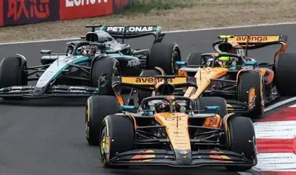 Formula 1 drivers battling for position during the Chinese Grand Prix with hybrid engine cars