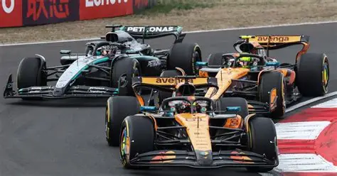 Formula 1 drivers battling for position during the Chinese Grand Prix with hybrid engine cars