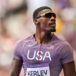 Fred Kerley competing in a 100m race at an athletics event