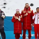 German Paralympic skiers turn away during the Russian national anthem at the medal ceremony.