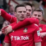 David Brooks celebrating with Wales jersey after overcoming cancer