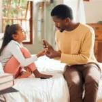 Father helping child manage diabetes using a mobile app