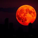 Total lunar eclipse turning the moon red during the blood moon event