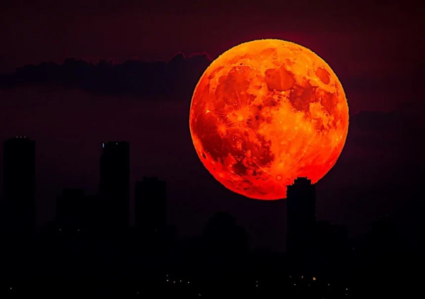 Total lunar eclipse turning the moon red during the blood moon event
