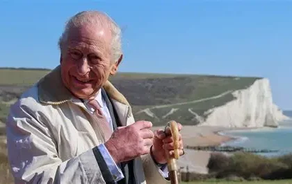King Charles walking along England Coast Path near Seven Sisters cliffs