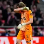 Tottenham goalkeeper Antonin Kinsky walking off the pitch after early substitution against Atletico Madrid