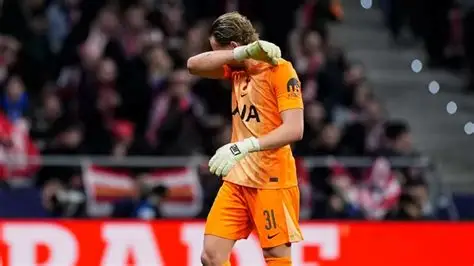 Tottenham goalkeeper Antonin Kinsky walking off the pitch after early substitution against Atletico Madrid