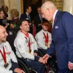 Pickle the guide dog with Hester Poole at ParalympicsGB House in Cortina