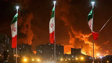 Man raising Iranian flag amid rubble after air strikes in Tehran
