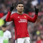 Casemiro celebrating a goal for Manchester United in front of fans at Old Trafford