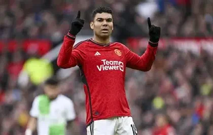 Casemiro celebrating a goal for Manchester United in front of fans at Old Trafford