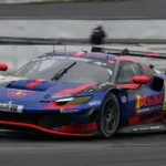Max Verstappen driving a Mercedes AMG GT on a racetrack