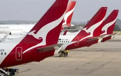 Qantas aircraft parked at an airport amid refund settlement news