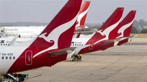 Qantas aircraft parked at an airport amid refund settlement news