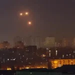 Drone attack damage in Ukraine with burning buildings and emergency response