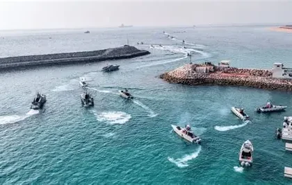 Smoke rising over the Gulf region as seen from a cargo ship near the Strait of Hormuz.